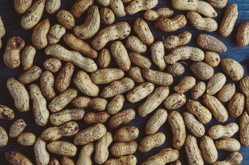 Peanuts in the shell on a dark wooden background