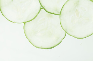 Cucumber slicing / Abstract image of a cucumber being sliced