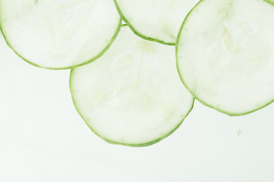 Cucumber slicing / Abstract image of a cucumber being sliced
