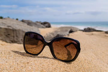 Sunglass on Sand at Beach