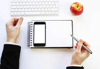 notebook and mobile phone on a white background. Schedule. work with business objects.