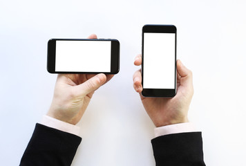  two smartphones in the hands. on a white background 