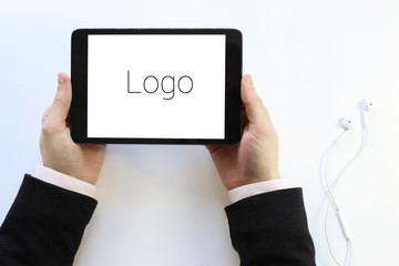 tablet in his hands. Logo