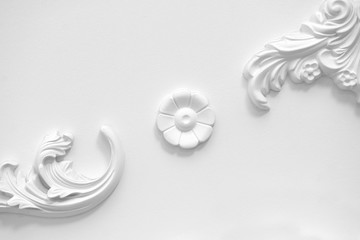 Stucco elements on white wall