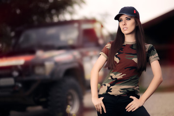 Female Driver in Army Outfit Next to an Off Road Car © nicoletaionescu