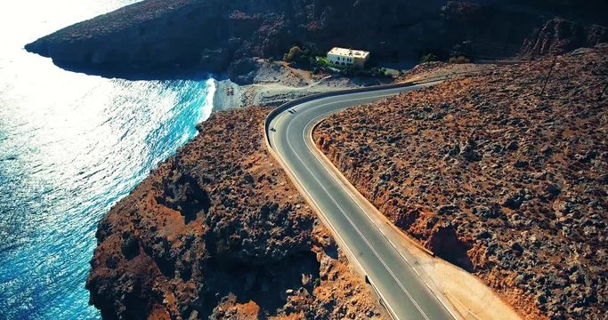 flying above road by seashore