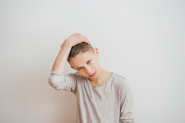 Portrait of a young boy touching his hair