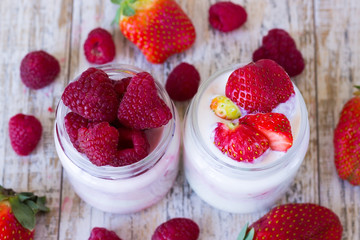 Two jars homemade yogurt with berries