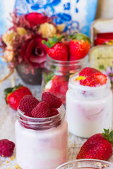 Two jars of home berry yoghurt with strawberries and raspberries