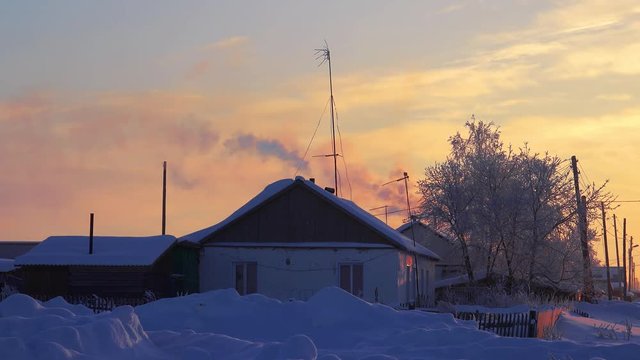 Smoke from the chimney of russian country house izba in Altai village Semiletka, Siberia, Russia
