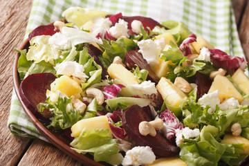 Dietary food: salad of beets, pineapple, cream cheese and greens closeup. horizontal