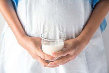 Pregnant woman holding glass of milk