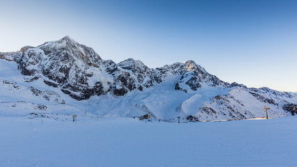 Fototapeta na wymiar Ski winter season, ski run in Italian Alps. Solda with Ortler, Zebru, Grand Zebru in background. Val Venosta, South Tirol, Italy.