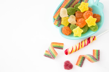 Candy background. Colorful candies in plate on light background