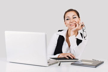 Young happy businesswoman working in the office and using laptop computer