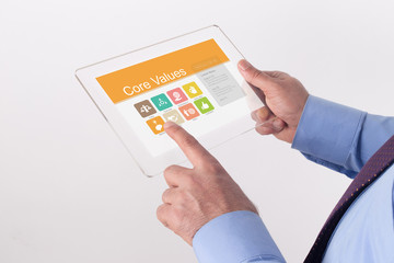 Hand Holding Transparent Tablet PC with Core Values screen