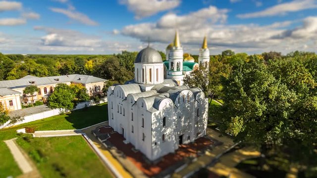 Tiny white church in green park with tilt shift effect. St. Boris and Hlib Church Ukraine/Chernihiv