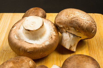 mushroom champignons on a wooden Board