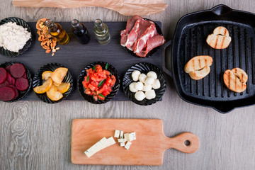 Bruschetta Ingredients for preparation near grill pan. Italian food. Antipasto.