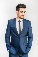 Young attractive man in a blue suit  on a white background. Isolated
