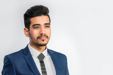 Young attractive man in a blue suit on a white background. Isolated