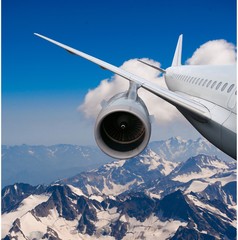 Fototapeta premium plane flying over the snow-capped mountains.