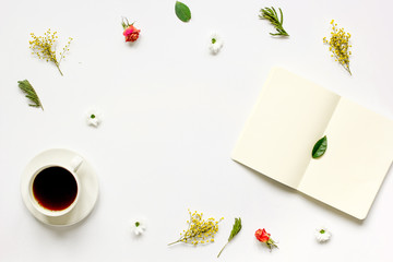 Notebook with cup of coffee on white background top view mockup
