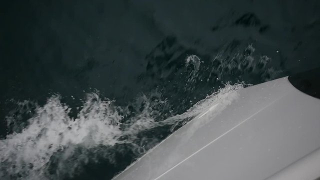 Bow of white yacht breaks of sea waves in Greece. Top view. Regatta. Adventures in the ocean. Slow motion.