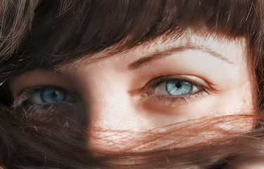 Blue eyes looking through the hair