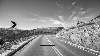 Black and white picture of a mountain road turn