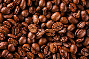Macro image of brown roasted coffee beans background.