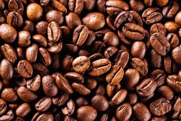 Macro image of brown roasted coffee beans background.