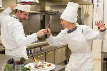 funny match in kitchen between chefs
