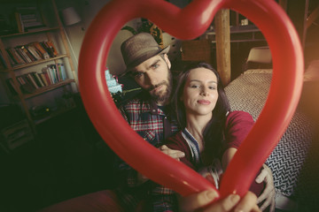 Couple holding a heart shaped balloon