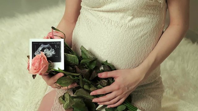 Happy future parents looking at pregnancy ultrasound photo