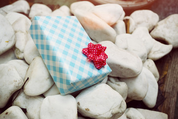 Wrapped gift on a white rocks
