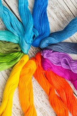 colorful sewing threads for embroidery on white background