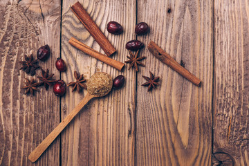 Anise and cinnamon sticks on a wooden background.