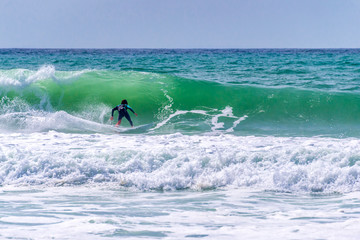 Surfer riding a huge wave during  World surf league competition in Lacanau, France