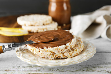Delicious rice wafers with chocolate on white plate