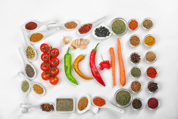 Different spices and fresh vegetables on white background