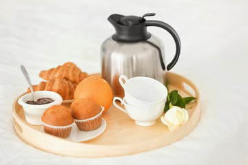 Fresh coffee with breakfast on wooden tray, closeup