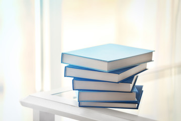 Stack of new books on table