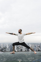 Fototapeta premium Man Practice Yoga Rooftop Concept