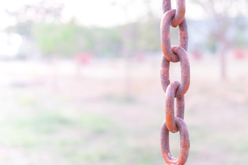 old red rust iron chain with blur background.