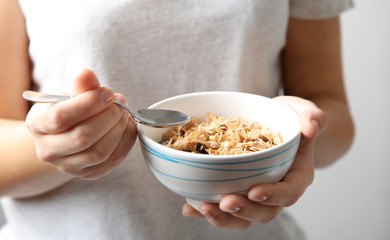 Closeup of woman holding bowl with healthy breakfast