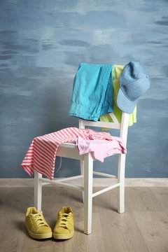 Pile Of Clothes On Wooden Chair