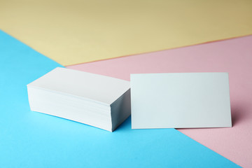 Stack of blank business cards on color paper background