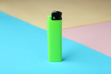 Blank cigarette lighter on color paper background