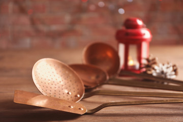 Set of metal kitchen utensils on wooden table